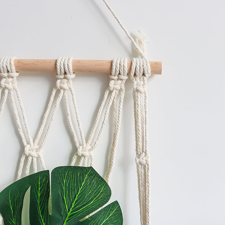 Elegant macramé wall hanging with decorative tassels and wooden frame
