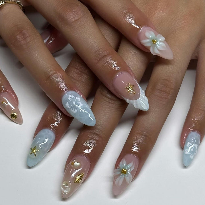 Artful nail extensions with delicate floral designs and glitter accents Bowlift