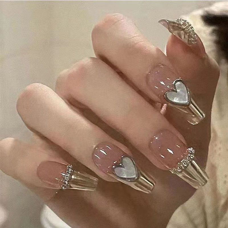 Glamorous artificial nails with heart design and glittering accents Bowlift