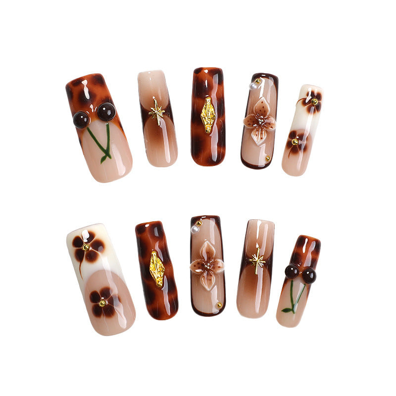 Elegant nail art set with floral and golden accents Bowlift