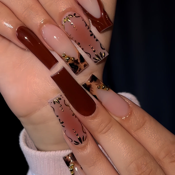 Artistic Long Press-On Nails with Elegant Gold Accents Bowlift