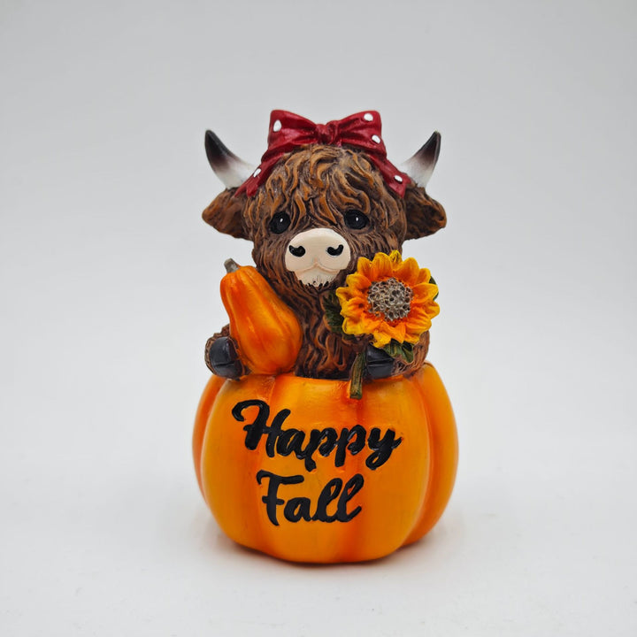 Funny decorative figure of a Highland cow in pumpkin costume Bowlift