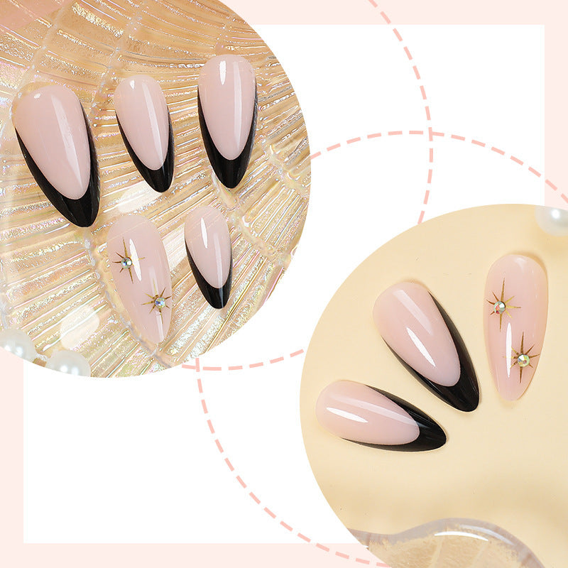 Artificial nail set with elegant black-and-white design and golden star accents Bowlift