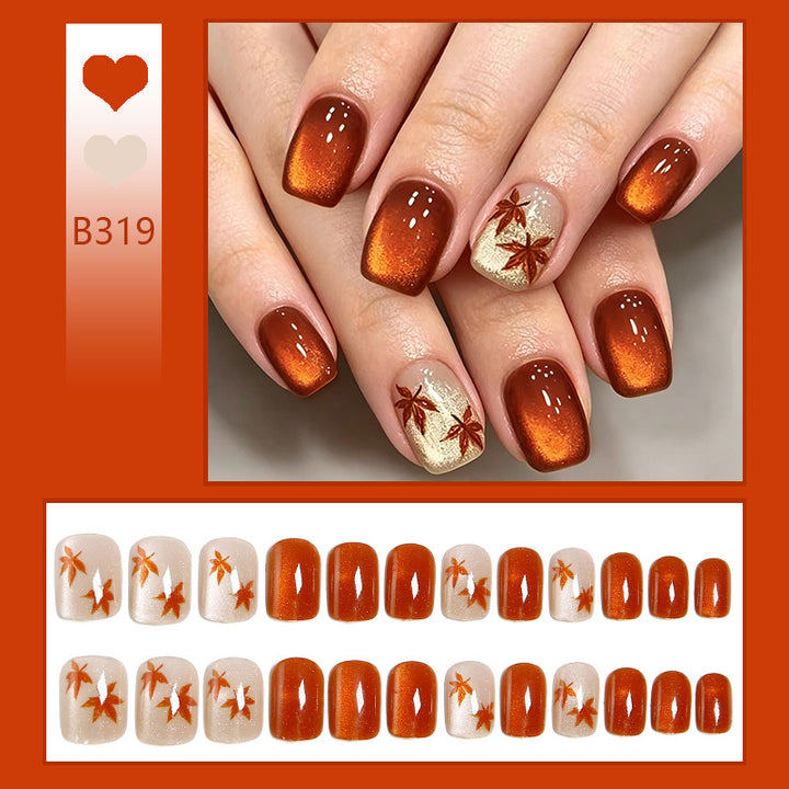 Artificial nails with glamorous ombre design and autumn leaf applications Bowlift