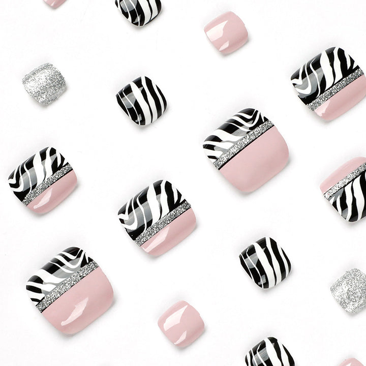 Artistic toenail art with zebra pattern and glitter accents Bowlift