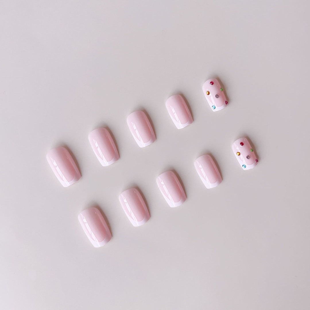 Nail art set with elegant French tips and sparkling rhinestone embellishments Bowlift