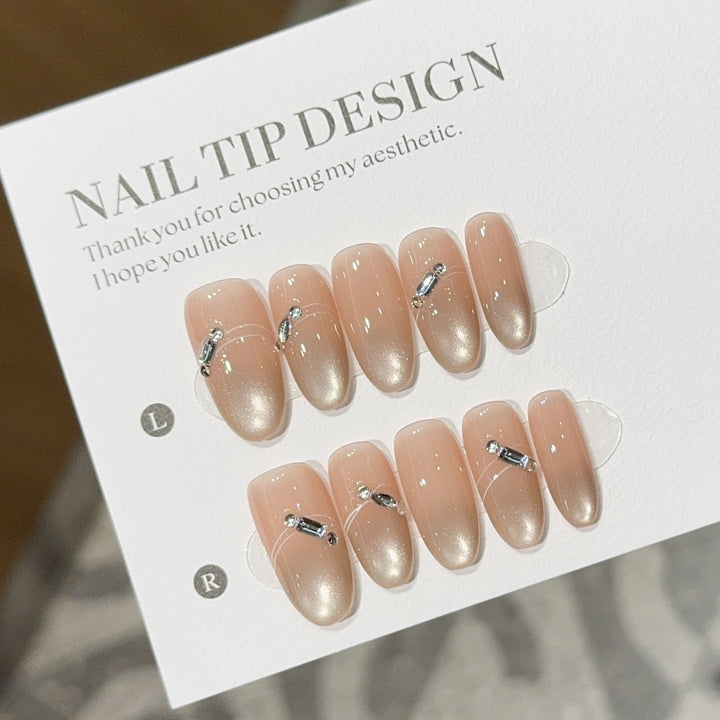 Artificial nail tips with elegant gradient color and rhinestone accents Bowlift