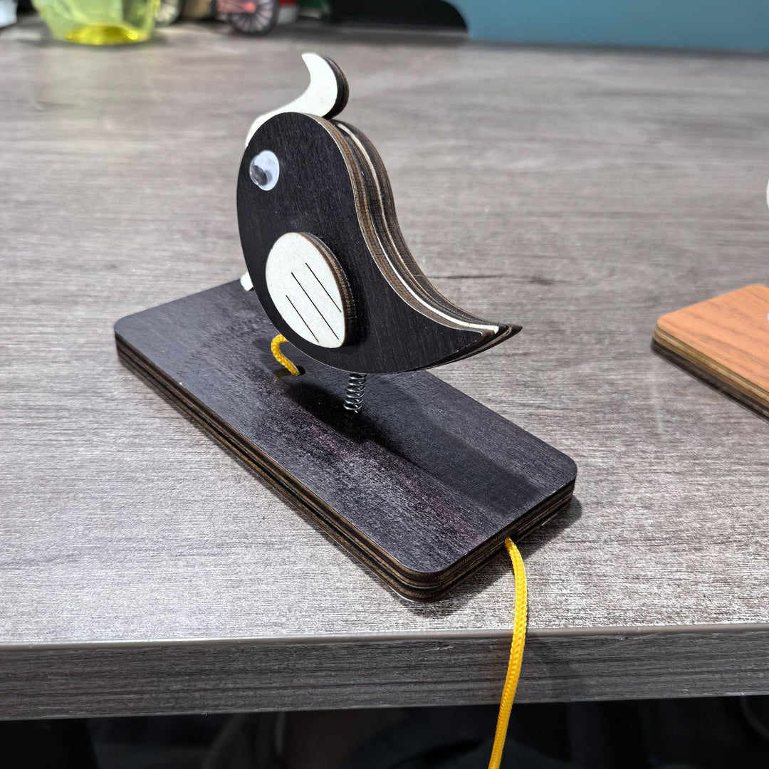Unisex nan movable wooden bird table figure made of plywood with spiral spring and pull line Bowlift