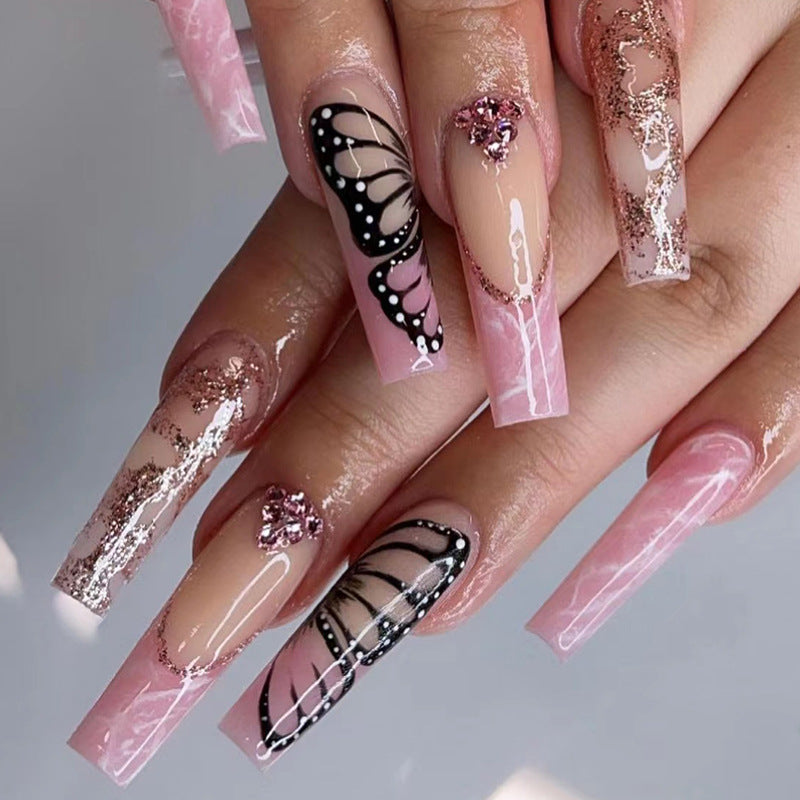 Glamorous nail extensions with beautiful butterfly motifs and glitter accents Bowlift