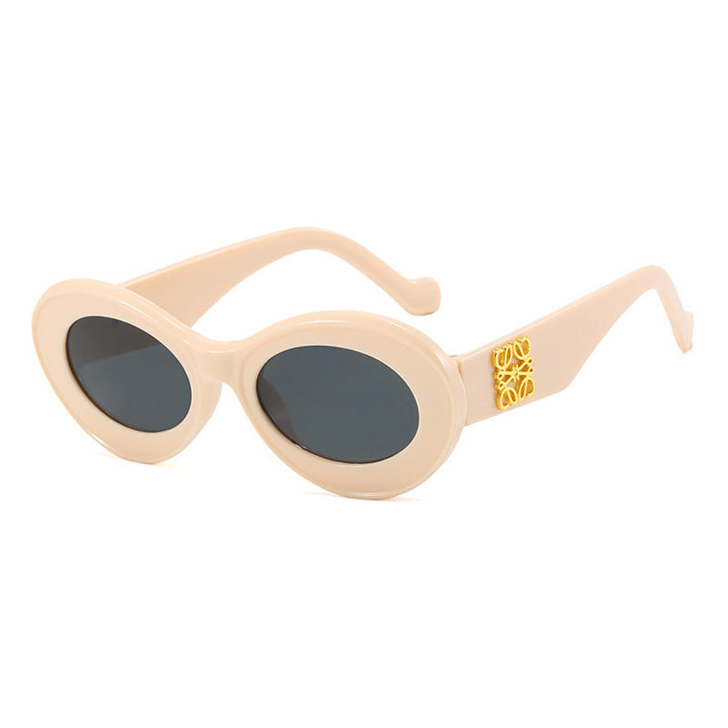 Women's fashionable sunglasses with oval frame and golden accents Bowlift