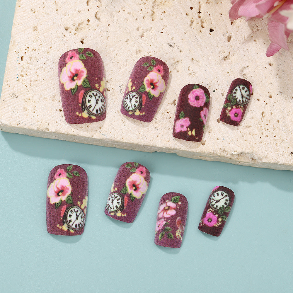 Nail art with floral design and intricate clock motifs Bowlift