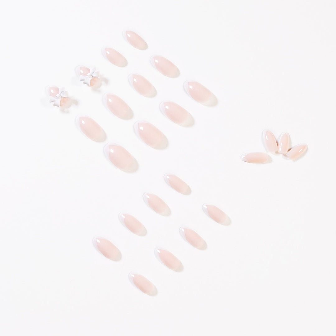 Elegant artificial nails with translucent French tip and decorative floral accents Bowlift