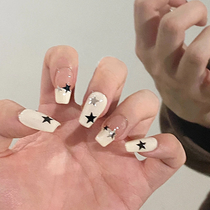 Artificial nail set with glamorous star design and sparkling accents Bowlift