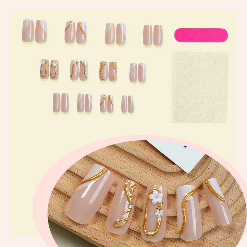 Elegant artificial nail set with golden accents and floral details Bowlift