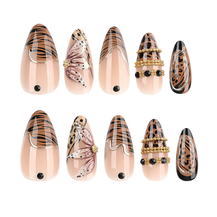 Artful stiletto nail with floral accents and gold embellishments Bowlift