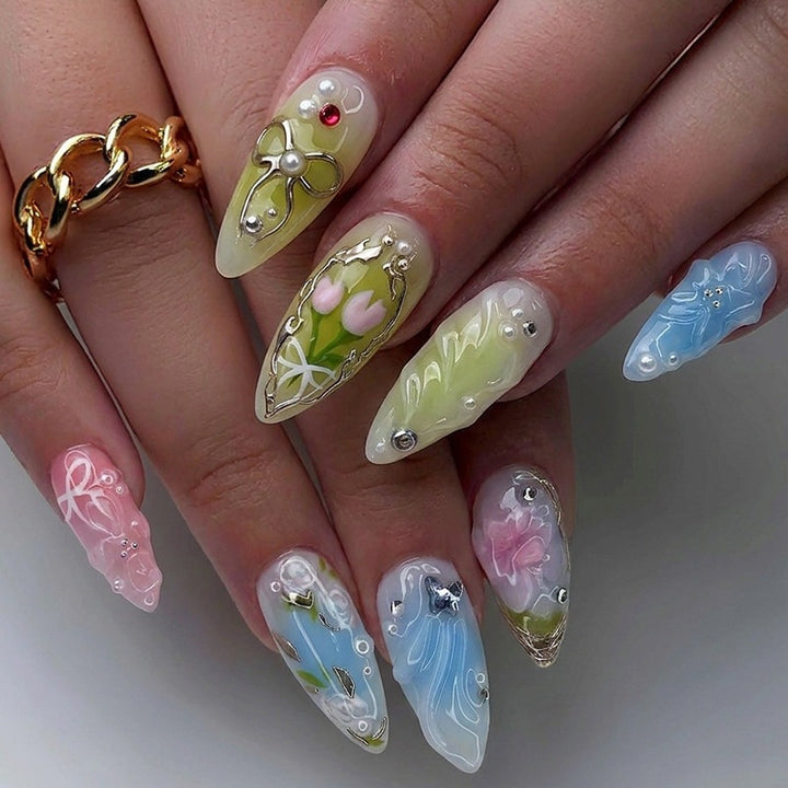 Creative nail set with hand-drawn floral patterns and glitter accents Bowlift