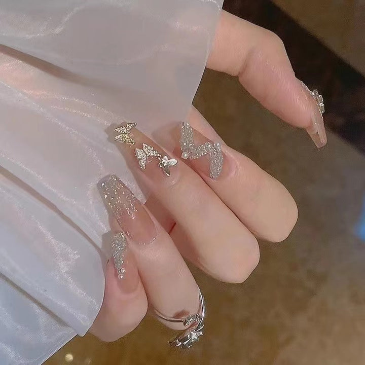 Glamorous nail art with rhinestone and butterfly elements Bowlift