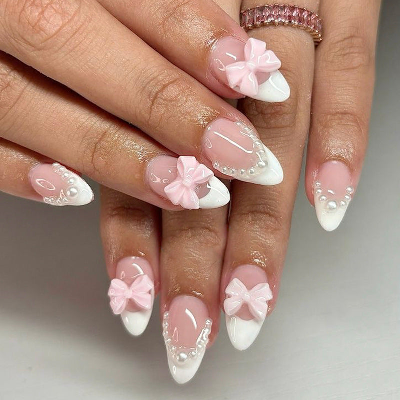 Artificial nail art with playful dots and bows Bowlift