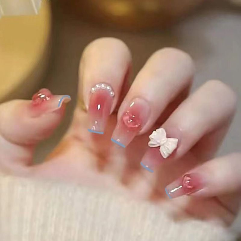 Artistic Nail Art with Glitter and Flower Applications Bowlift