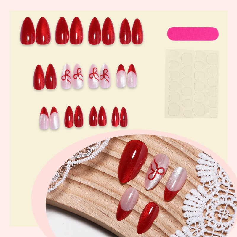 Artificial nail set with elegant red and delicate bow accents Bowlift