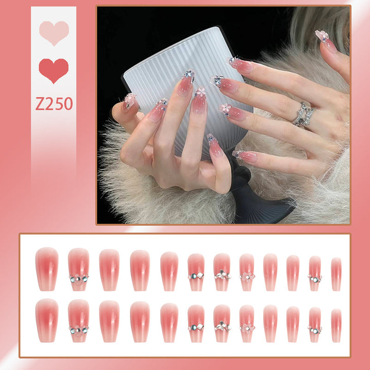 Artificial nail set with glamorous 3D decorations and shimmering accents Bowlift