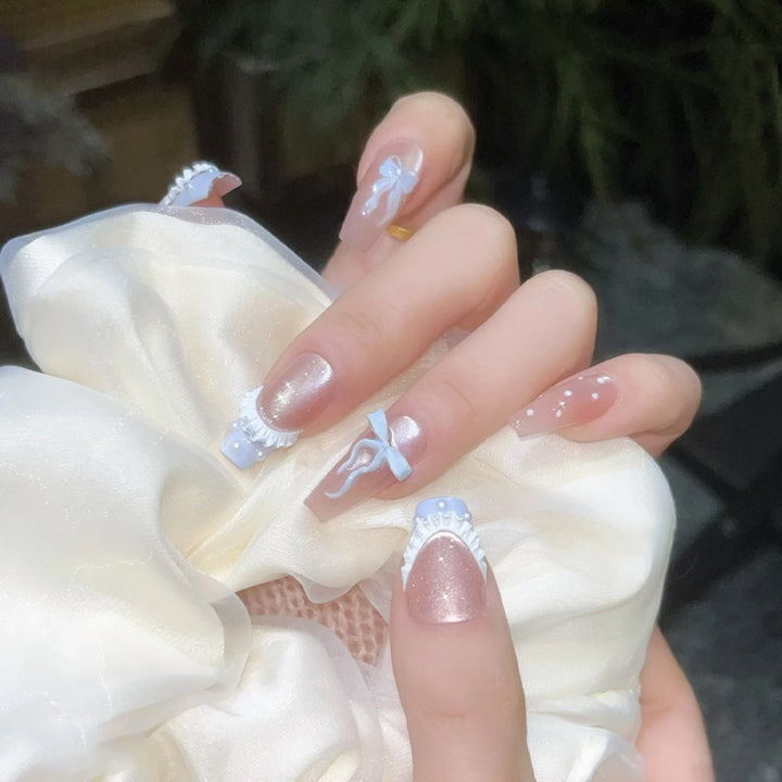 Art nail set with filigree bows and glitter accents Bowlift