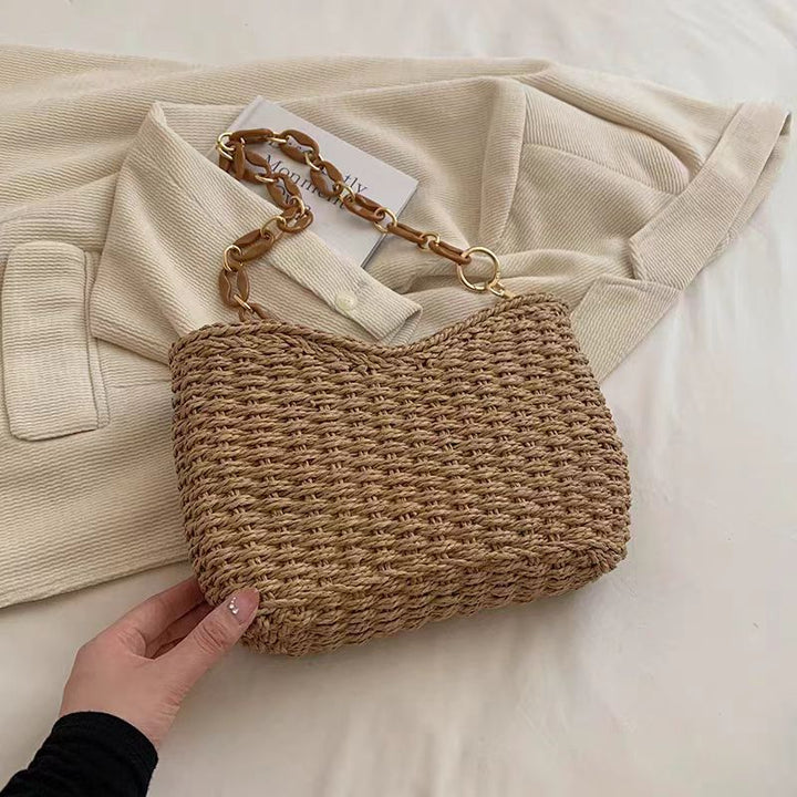 Handcrafted straw bag with golden chain details Bowlift