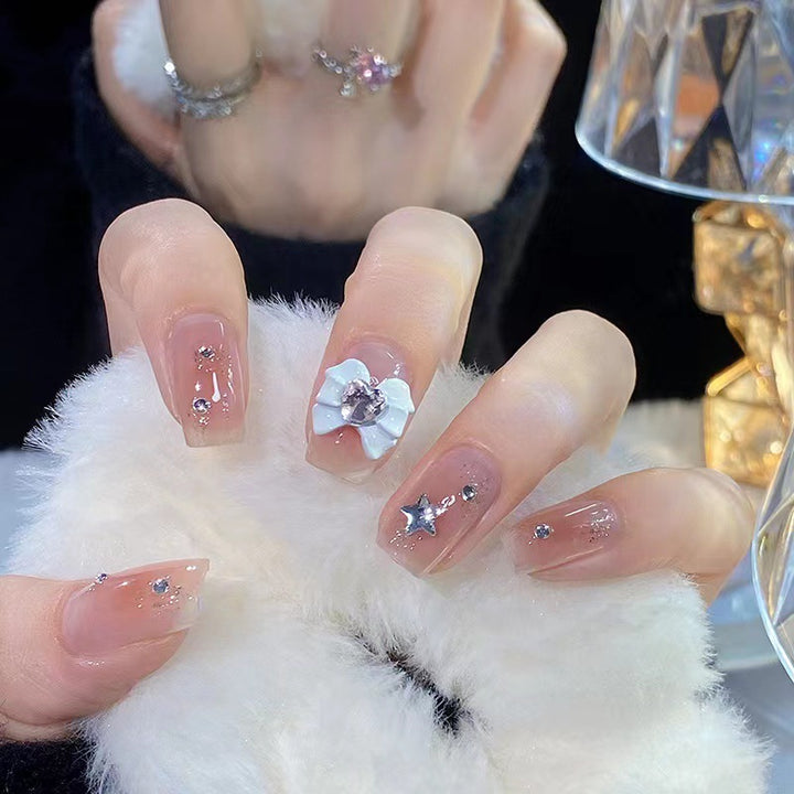 Artistic nail tips with floral and glittering accents Bowlift