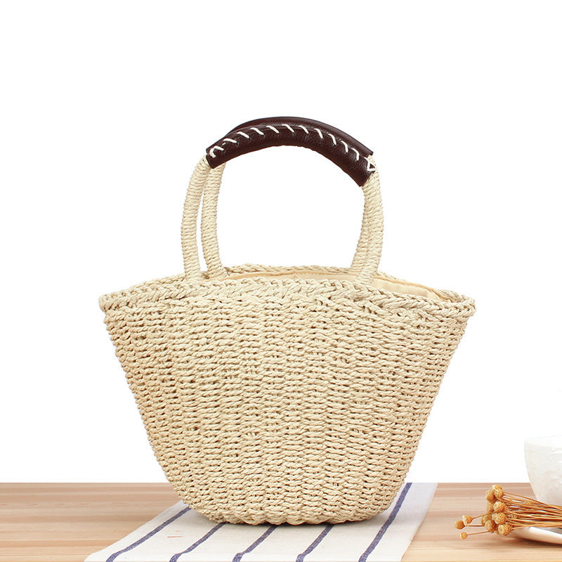 Basket bag made of woven natural material with leather handles Bowlift