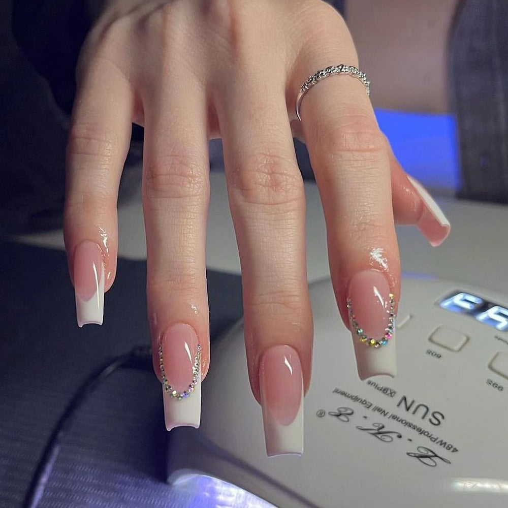 Elegant French Tip Acrylic Nail Extensions with Rhinestone Accents Bowlift