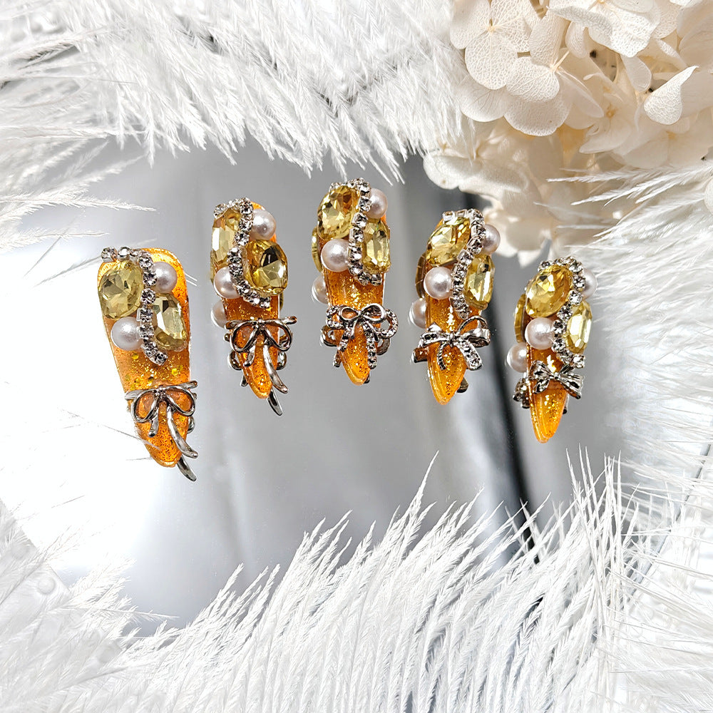 Glamorous artificial nails with rhinestones and pearl embellishments Bowlift