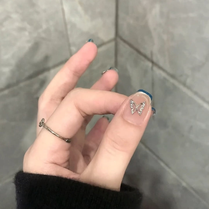 Artificial nails with trendy French tips and decorative glitter accents Bowlift