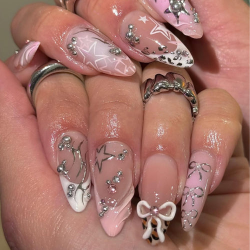 Artful stiletto nails with glitter and bow decorations Bowlift