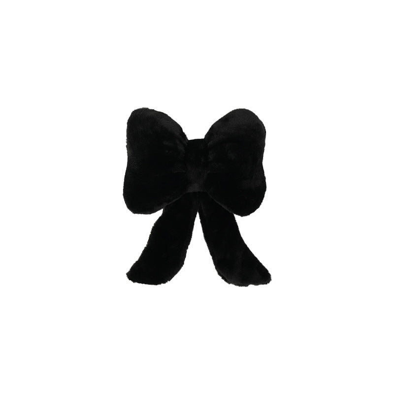 plush bow-shaped decorative throw cushion with long tails and faux-fur texture Bowlift