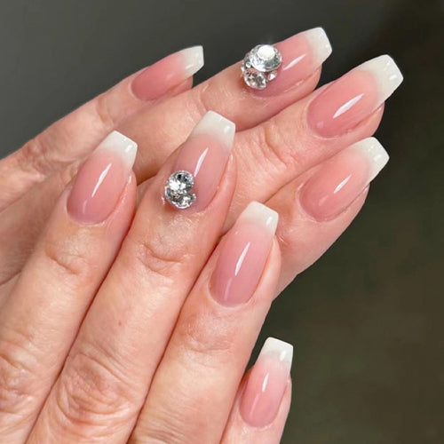 Artful nail extensions with elegant French tip and rhinestone embellishments Bowlift
