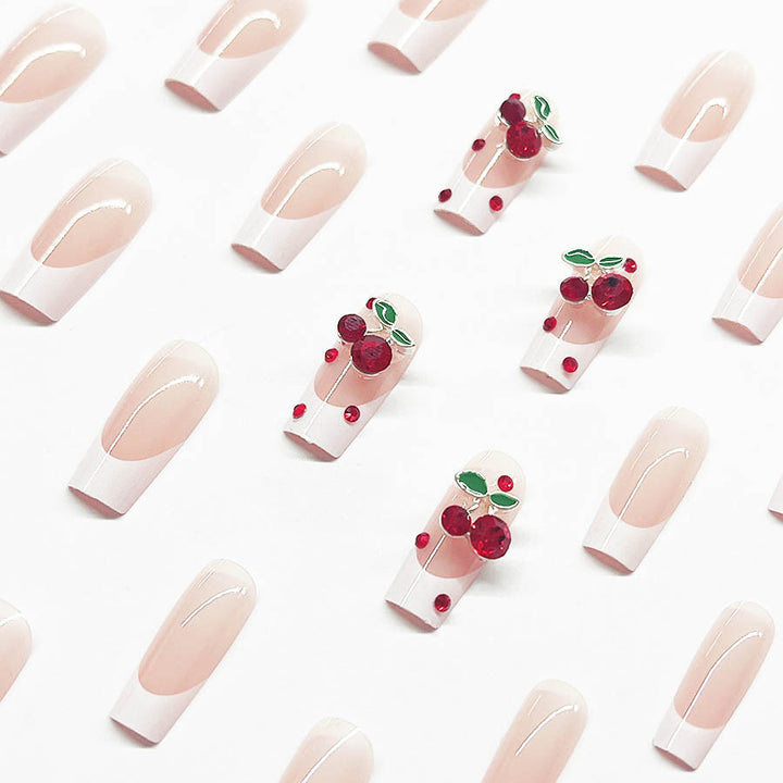 Acrylic nail set with chic cherry motifs and elegant French tip Bowlift