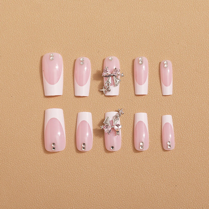 Artificial nail set with luxurious French tips and elegant embellishments Bowlift