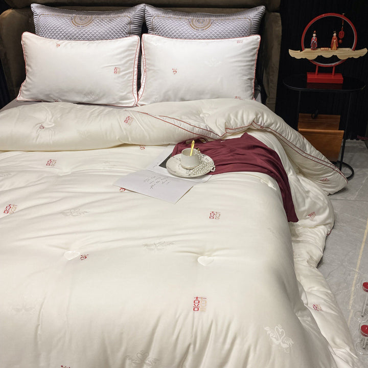 Luxurious cotton satin bedding set with quilted blanket and subtle embroidery