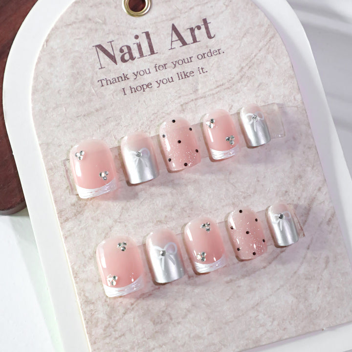 Artistic Nail Art with Bow and Glitter Accents Bowlift