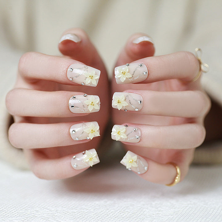 Artificials nails with sparkling rhinestone accents and elegant flower embellishments Bowlift