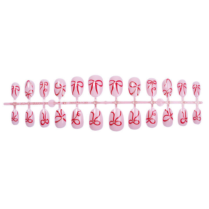 Artificial nail design with bow motifs Bowlift