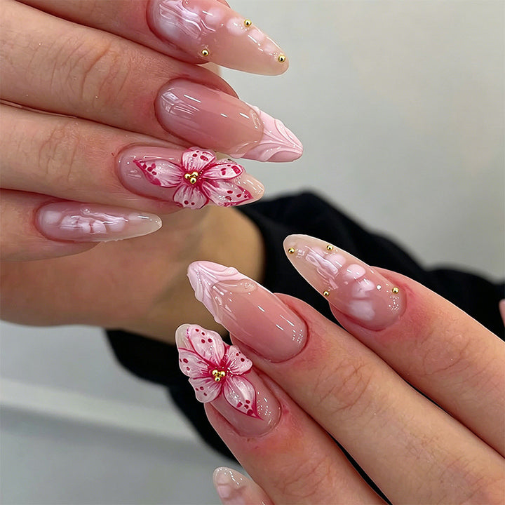 Artificial nail set with glamorous floral designs and creative glitter accents Bowlift