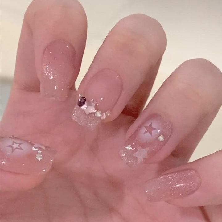 Glamorous artificial nails with heart design and glittering accents Bowlift
