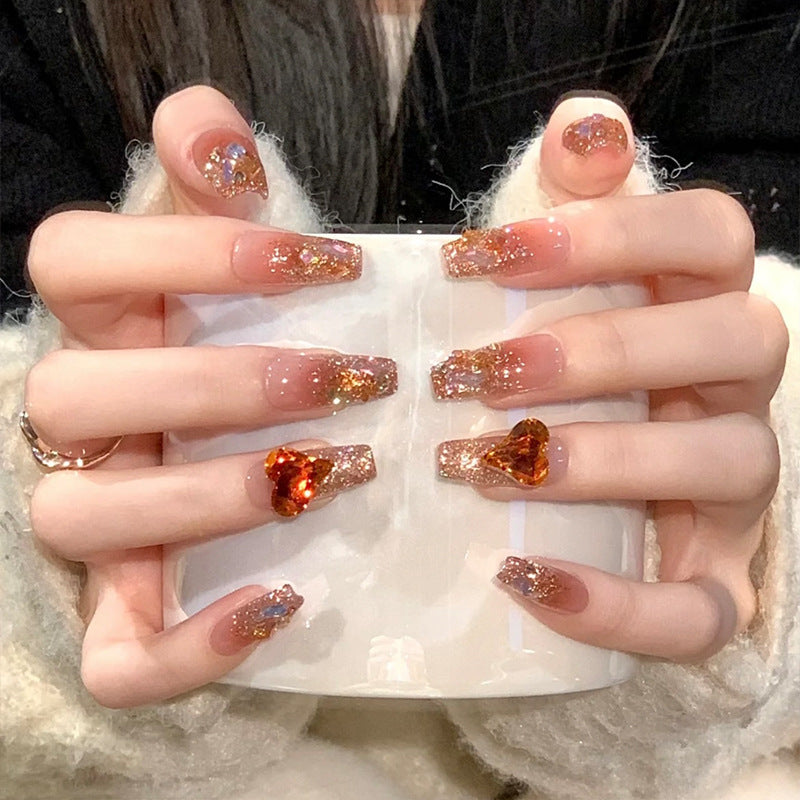 Artificial nail set with glitter and heart accents Bowlift