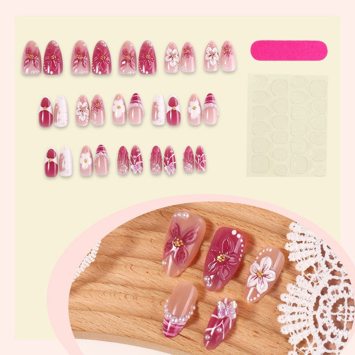Creative acrylic nail set with floral accents and glitter decorations Bowlift