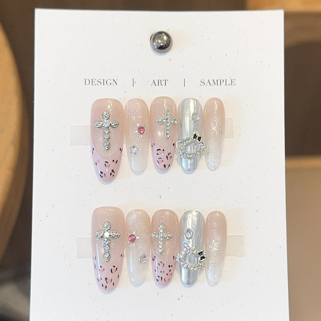 Artificial nails with sparkling rhinestones and cross motifs Bowlift