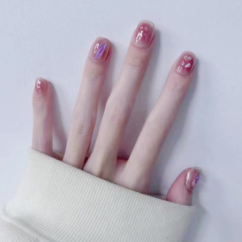 Artificial nails with delicate glitter design and floral accent Bowlift