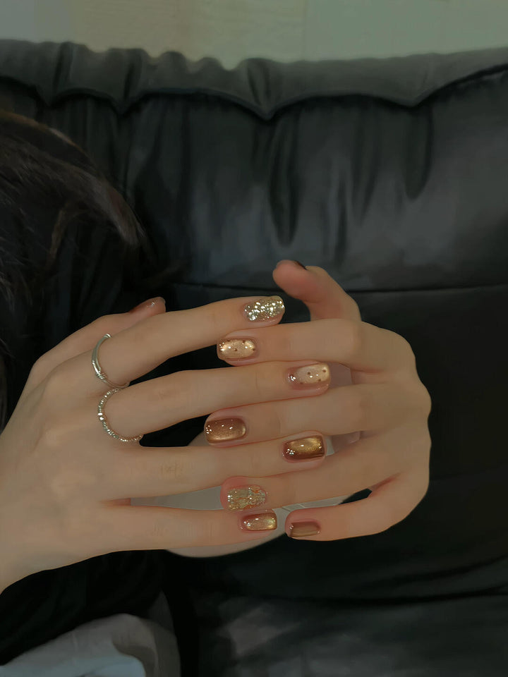 Elegant artificial nails with shimmering effects and sparkling accents Bowlift