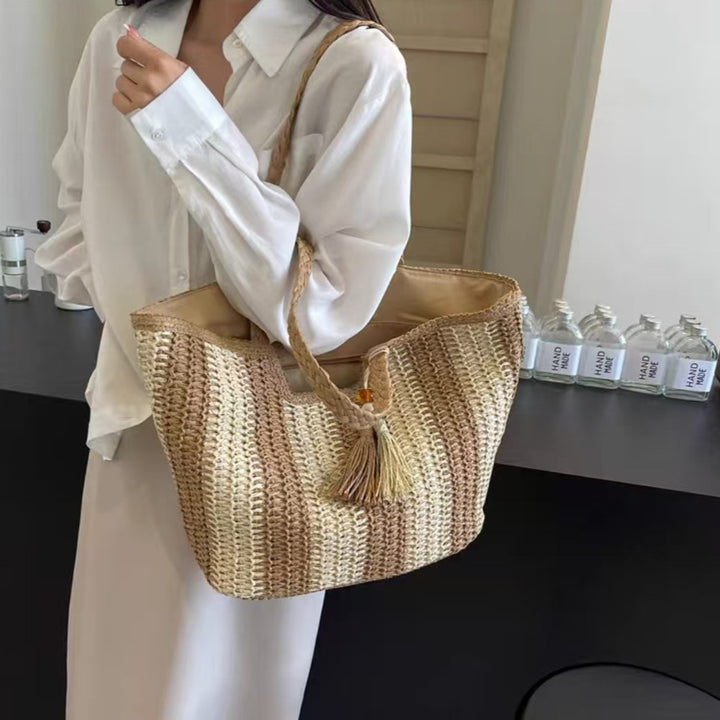 Beach bag with cheerful stripes and tassel details Bowlift