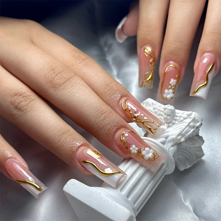 Elegant artificial nail set with golden accents and floral details Bowlift